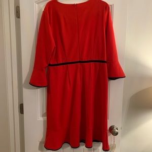 Beautiful Neiman Marcus red dress w/ black trim. Knee length w/ 3/4 bell sleeves